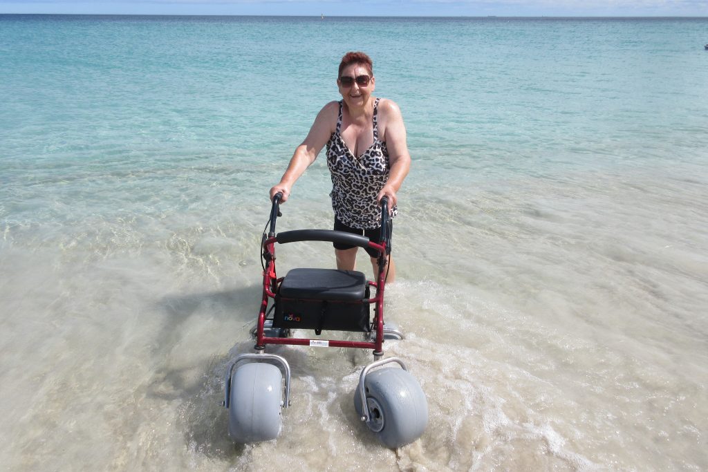 Woman with a walker in the sea