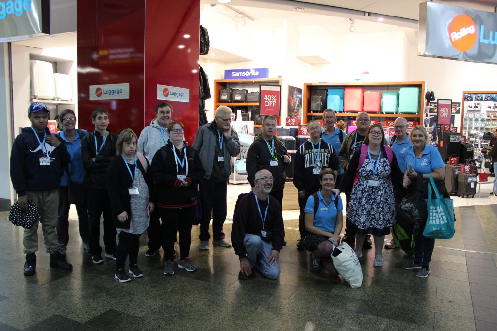 A supported group of travellers at the airport, getting ready to fly with Leisure Options.